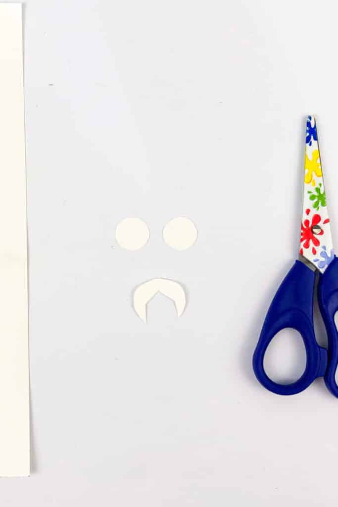 cutting out eyes and fangs using scissors