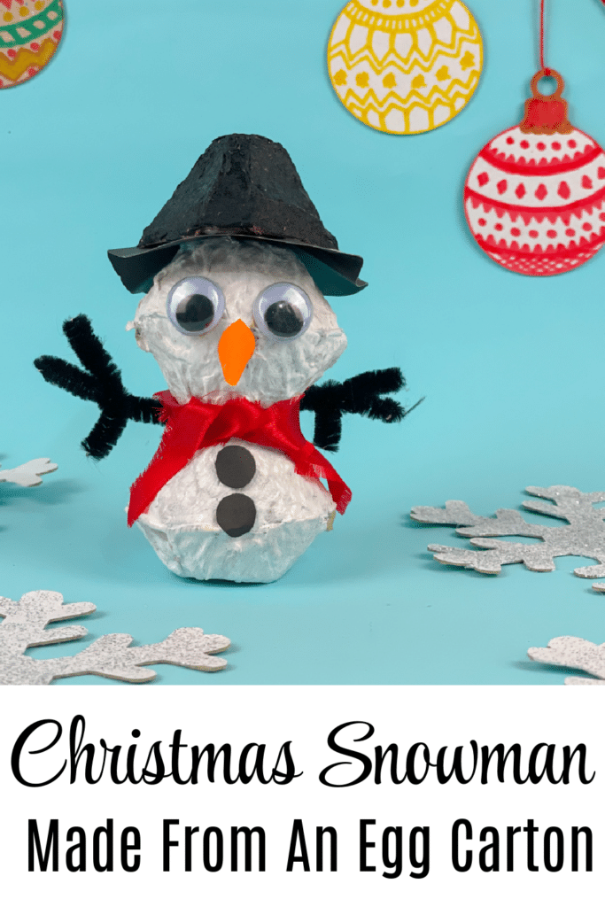 Christmas Snowman made from an egg carton on blue background