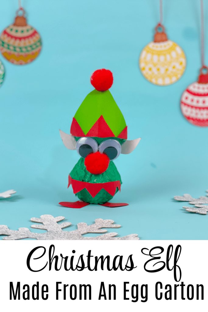 Christmas elf made from an egg carton on blue background