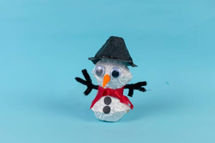Egg carton Snowman completed on blue background