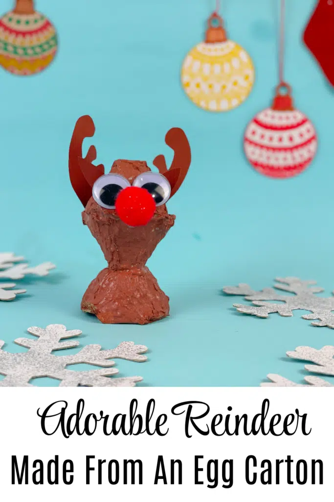 Pictured adorable reindeer craft made from egg carton on blue background