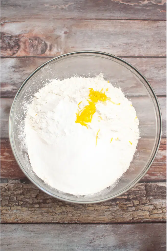 Large mixing bowl with lemon zest and flour mixture