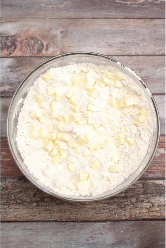 cutting in cold butter into scone dough in large glass bowl