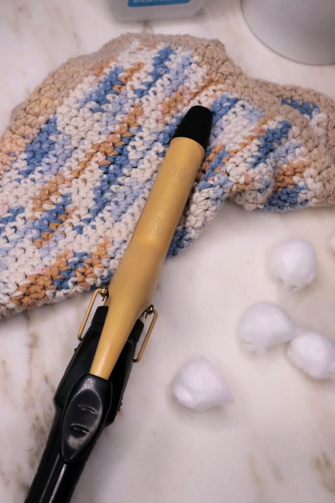 using cloth to wipe down curling iron
