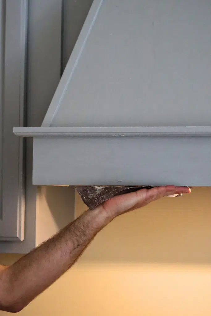 Preparing surface by sanding area with sandpaper