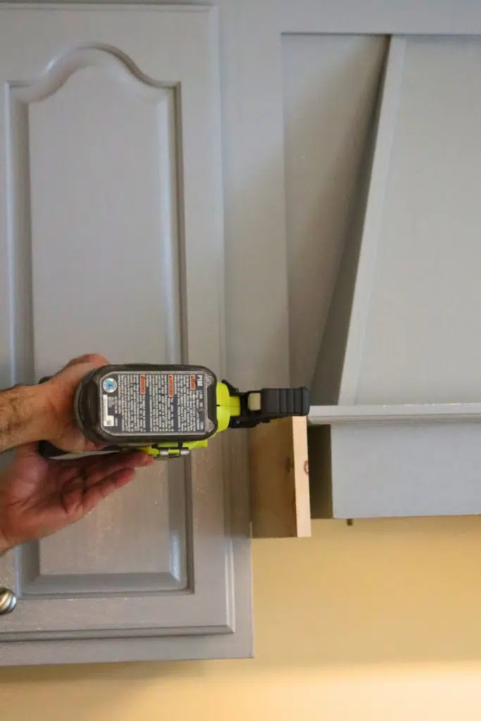 using nail gun to add wood pieces in place to hood range