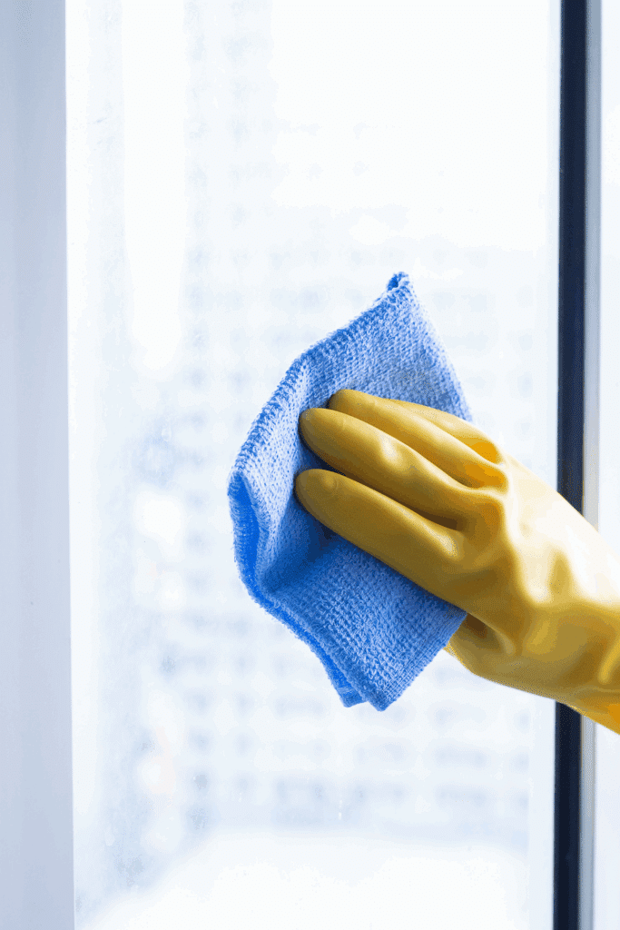 cleaning inside window with microfiber cloth