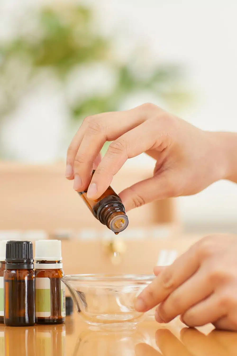 Mixing essential oils in small bowl