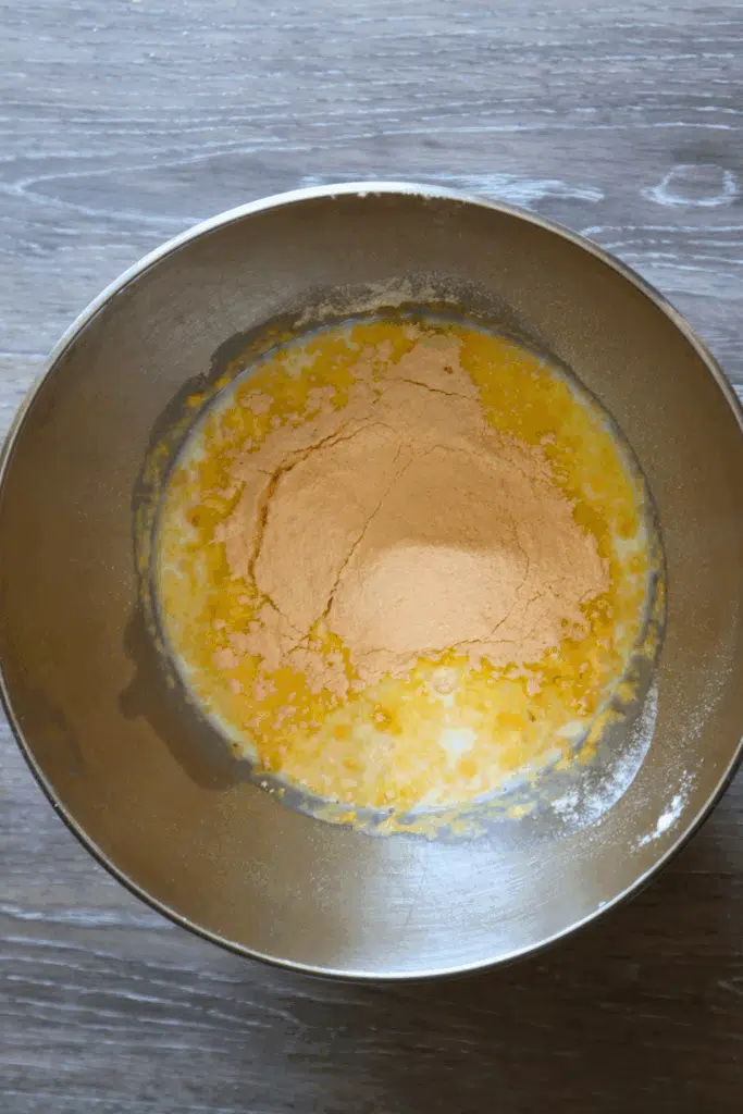 pudding and milk in mixing bowl for key lime eclair cake