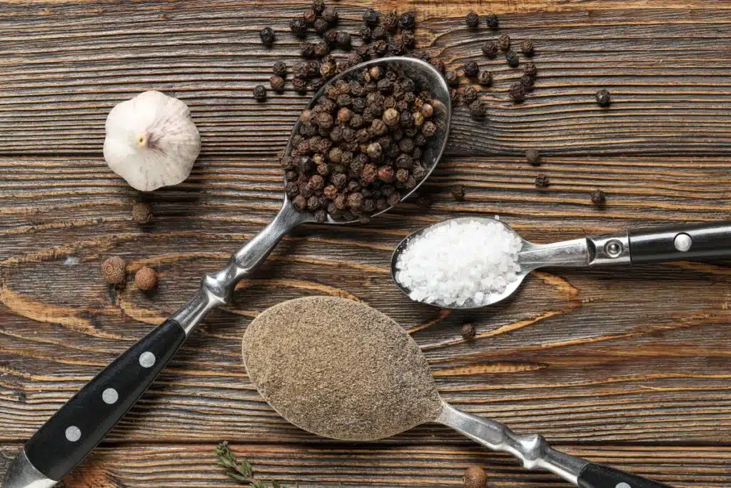 salt and peppercorns Photo Credit Canva Pro Stock Image