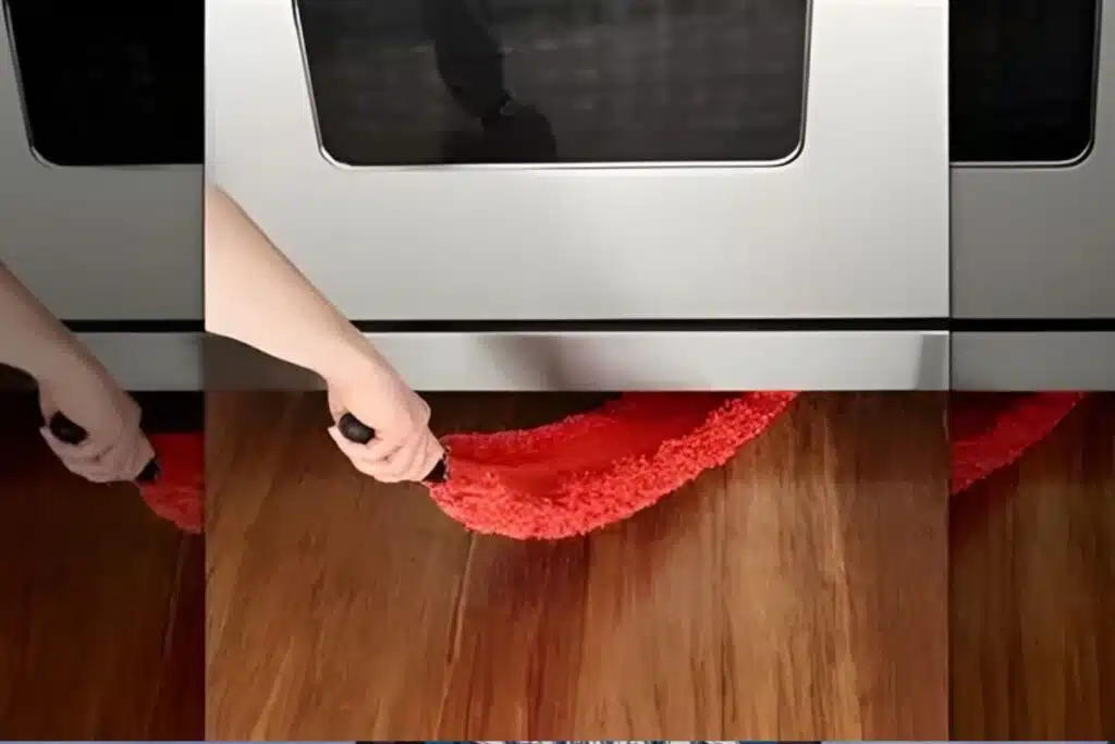 Cleaning under stove Photo Credit House Digest