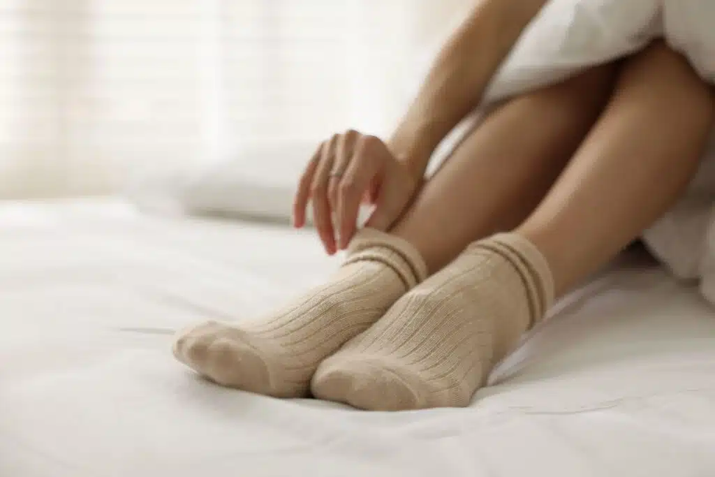 putting socks on Photo Credit Canva Pro Stock Image