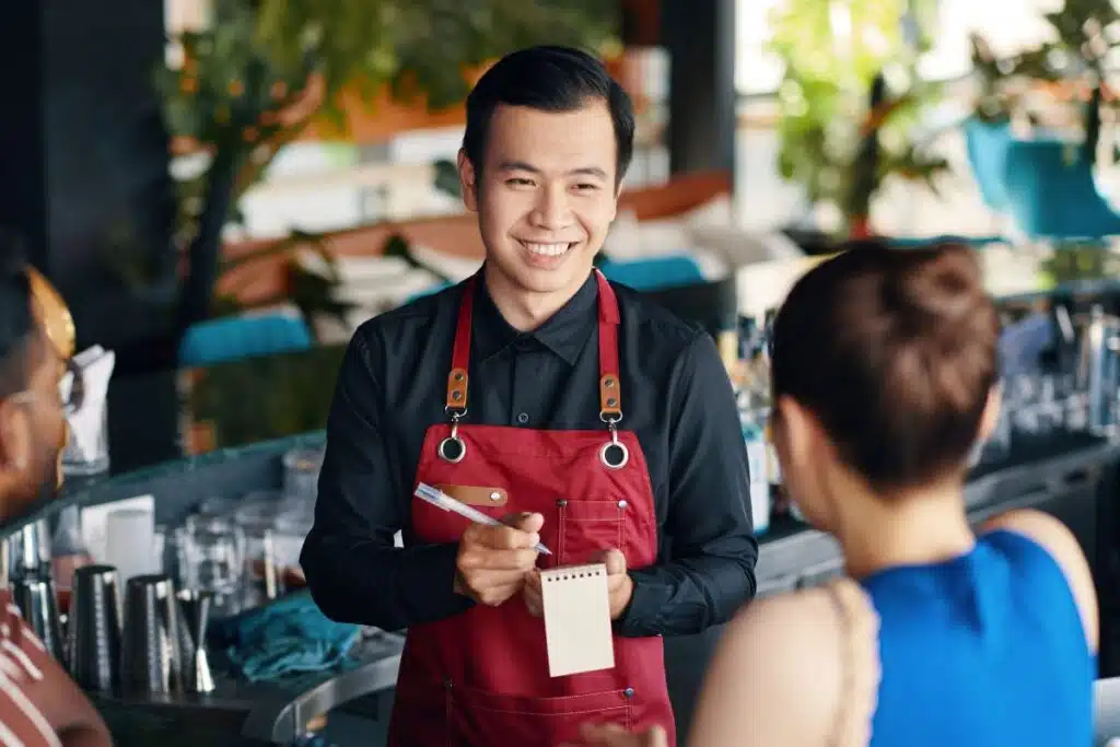 waiter at restaurant Credit Canva Pro Stock Image