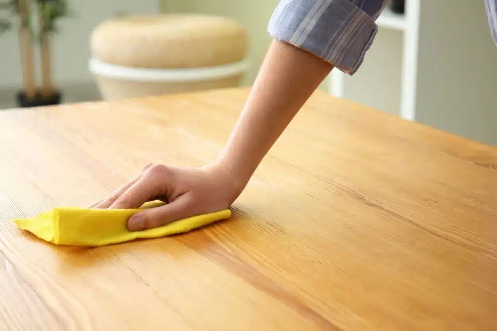 cleaning wood table, cloth, wiping Photo Credit Canva Pro Stock Image