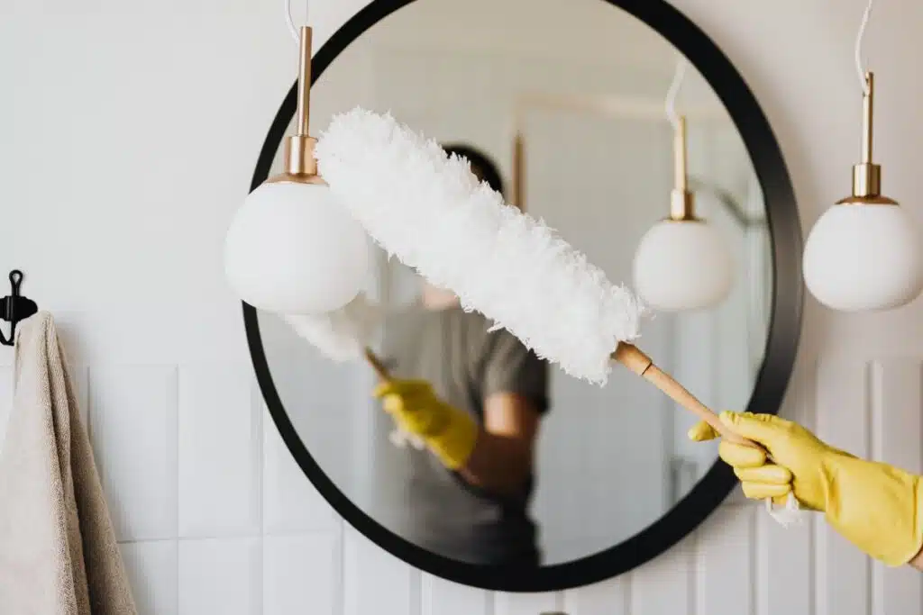 Dusting Mirror Bathroom Photo Credit Canva Pro Stock Image