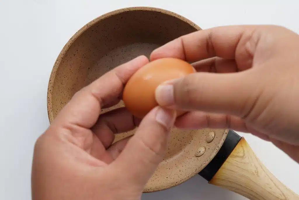 cracking eggs Photo Credit Canva Pro Stock Image