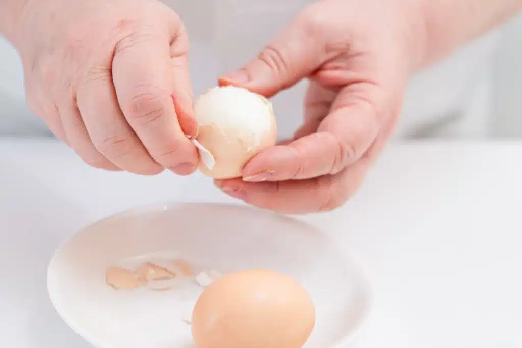 peeling eggs Photo Credit Canva Pro Stock Image