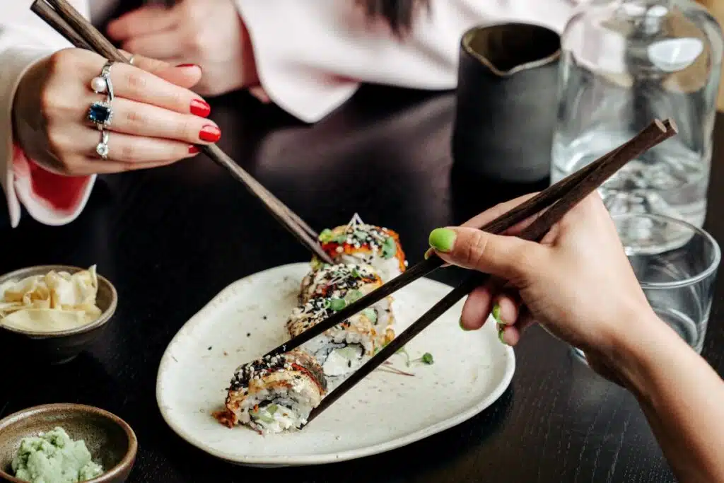 Sushi on plate with chopsticks Photo Credit Canva Pro Stock Image