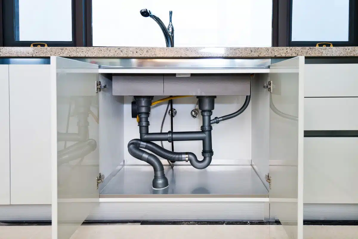 pipes under kitchen sink drain Image Credit Canva Pro Stock Image